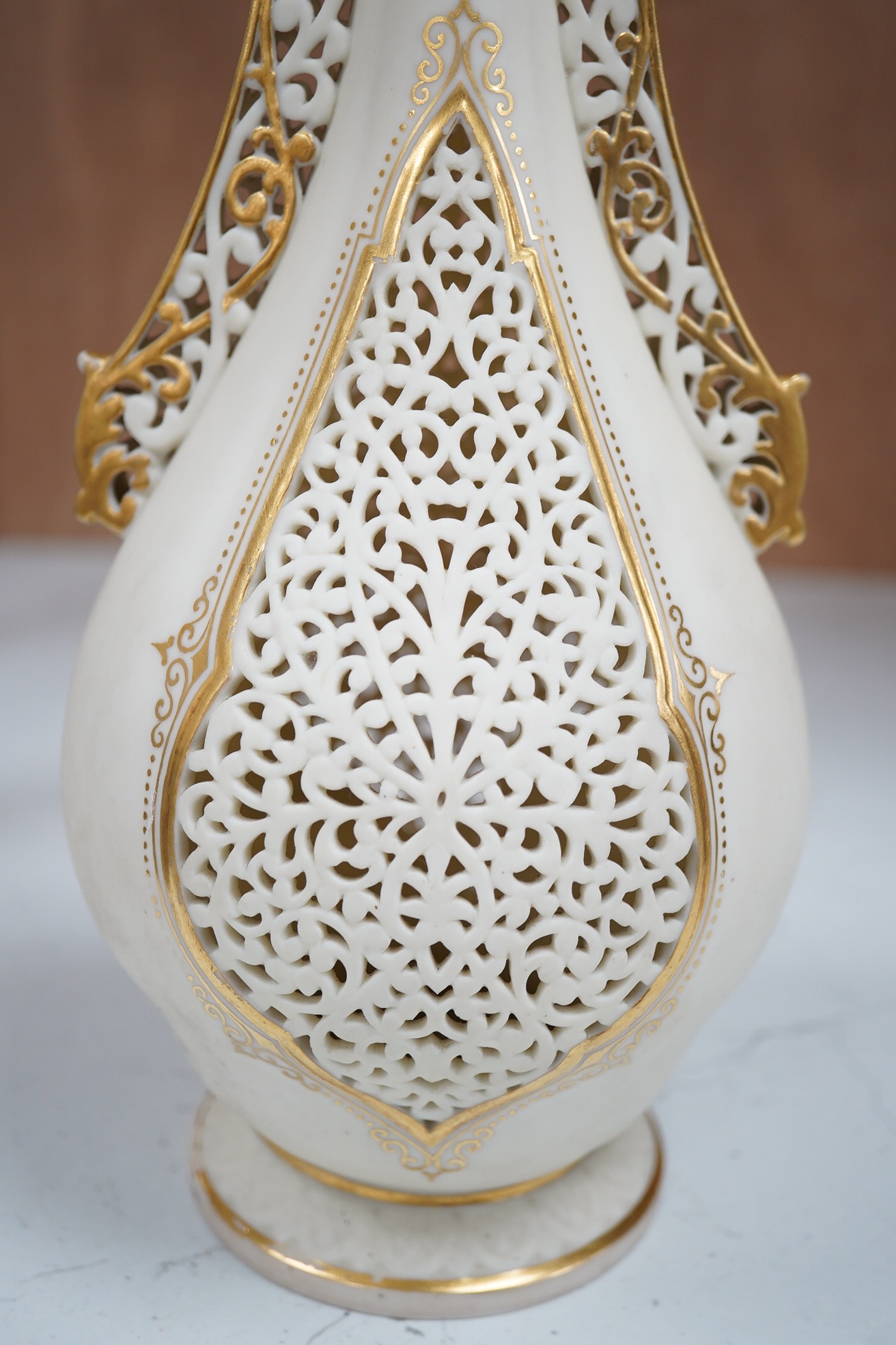 A Grainger's reticulated vase with gilded decoration, 30cm high. Condition - fair to good